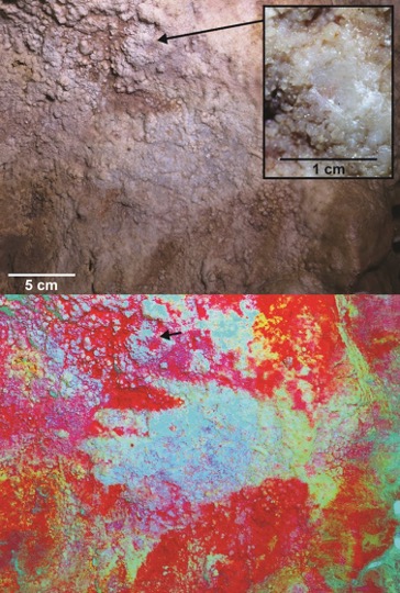Neanderthal hand stencils appear faintly on cave wall, identified by arrows.